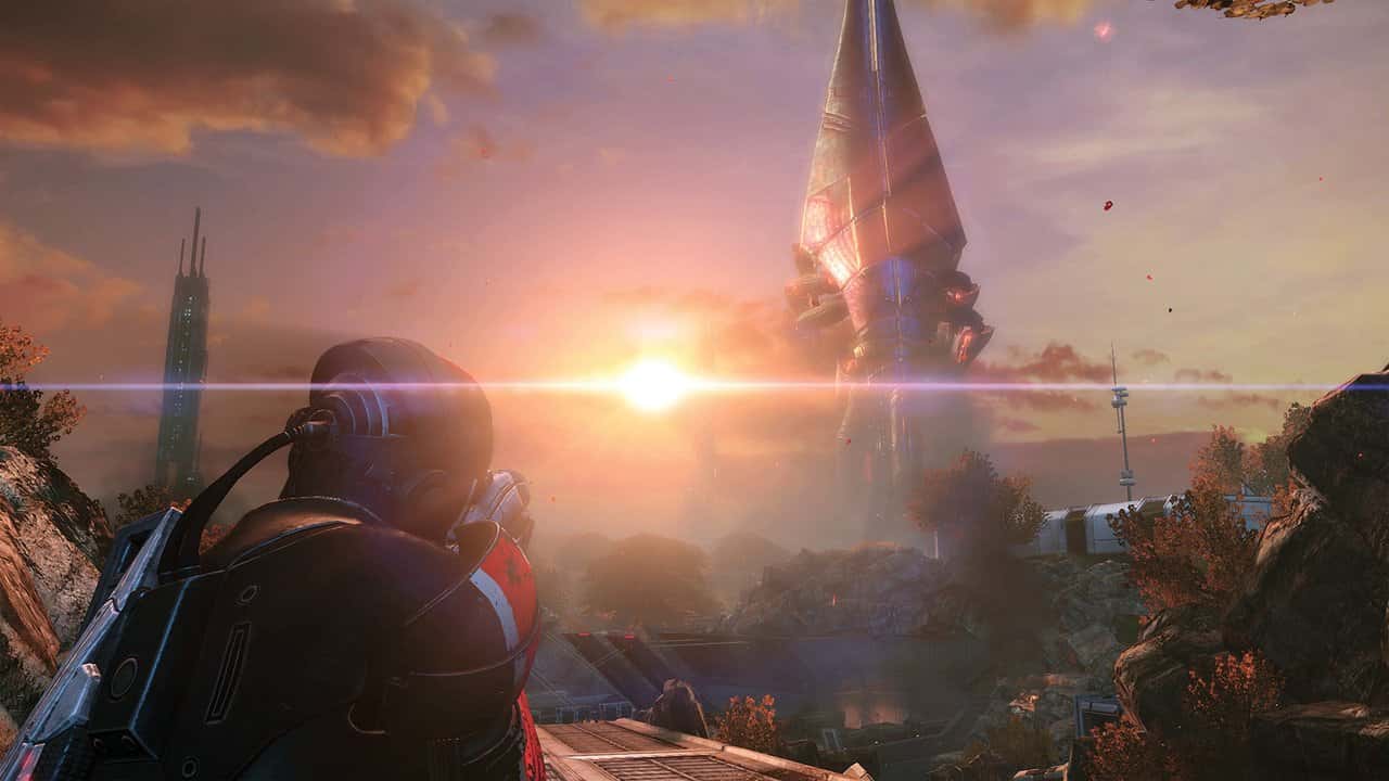 Mass Effect'te gün batımında yıkılmış bir şehirde dev bir Reaper'a bakan Komutan Shepard