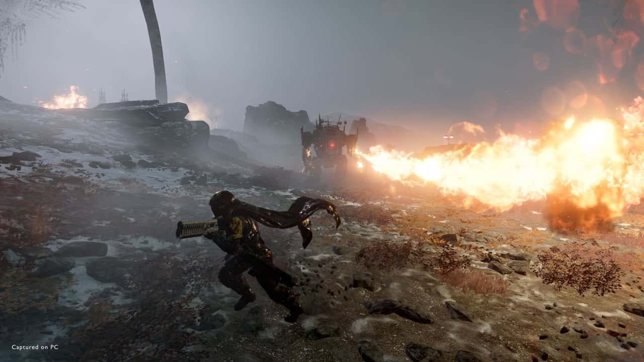 Helldivers 2'de karlı bir savaş alanında alev silahı kullanan bir Helldiver