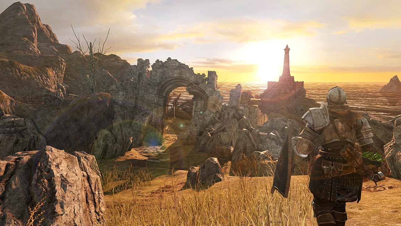 Dark Souls II'de gün batımında deniz fenerine bakan zırhlı bir karakter