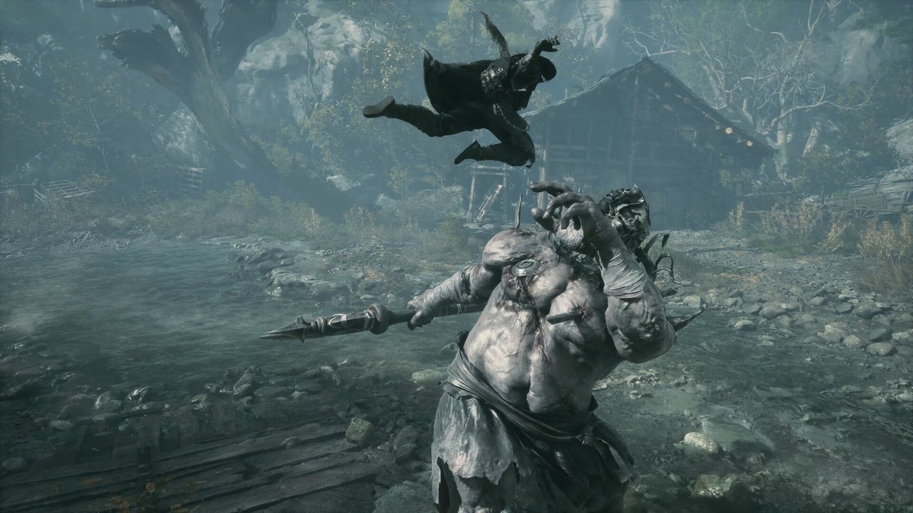 Soul fighting a hulking boss in a misty village in Phantom Blade Zero
