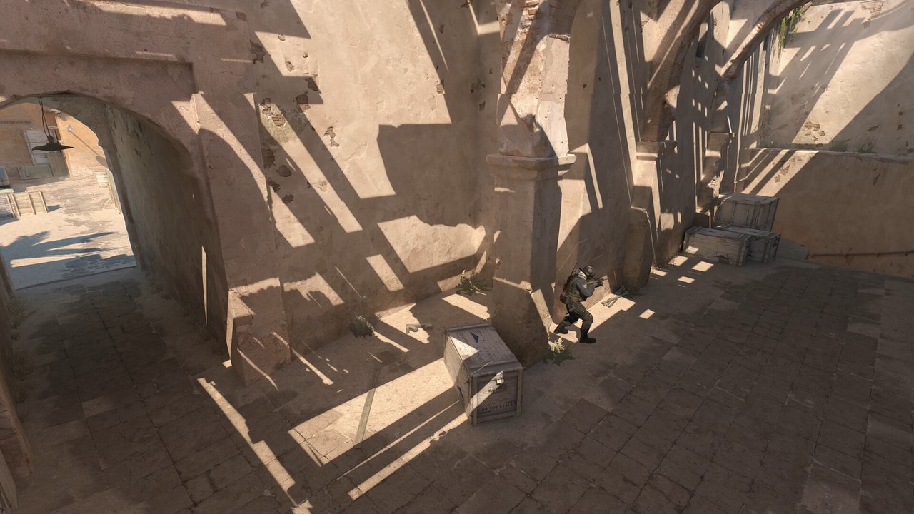 Counter-Strike 2'de güneş ışığı alan taş kemerli antik tapınak koridoru